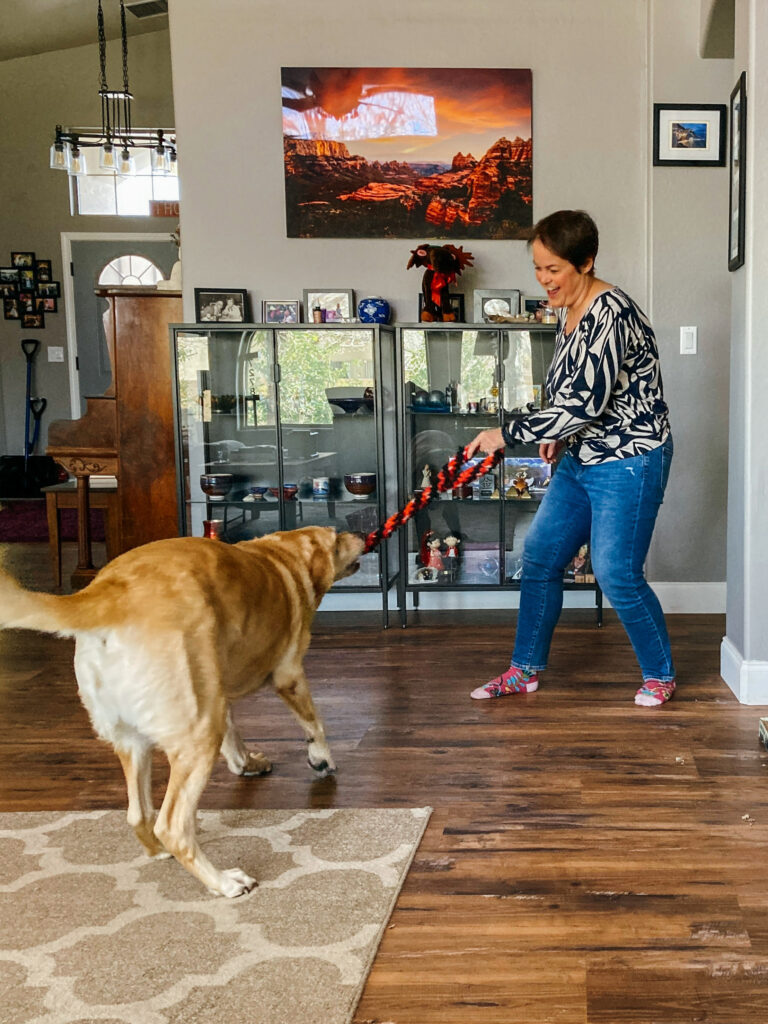 Lyn energized and playing with her dog